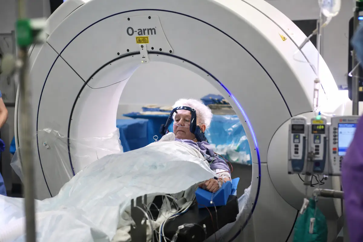 A patient resting awake inside the intraoperative scanner between stages of DBS surgery