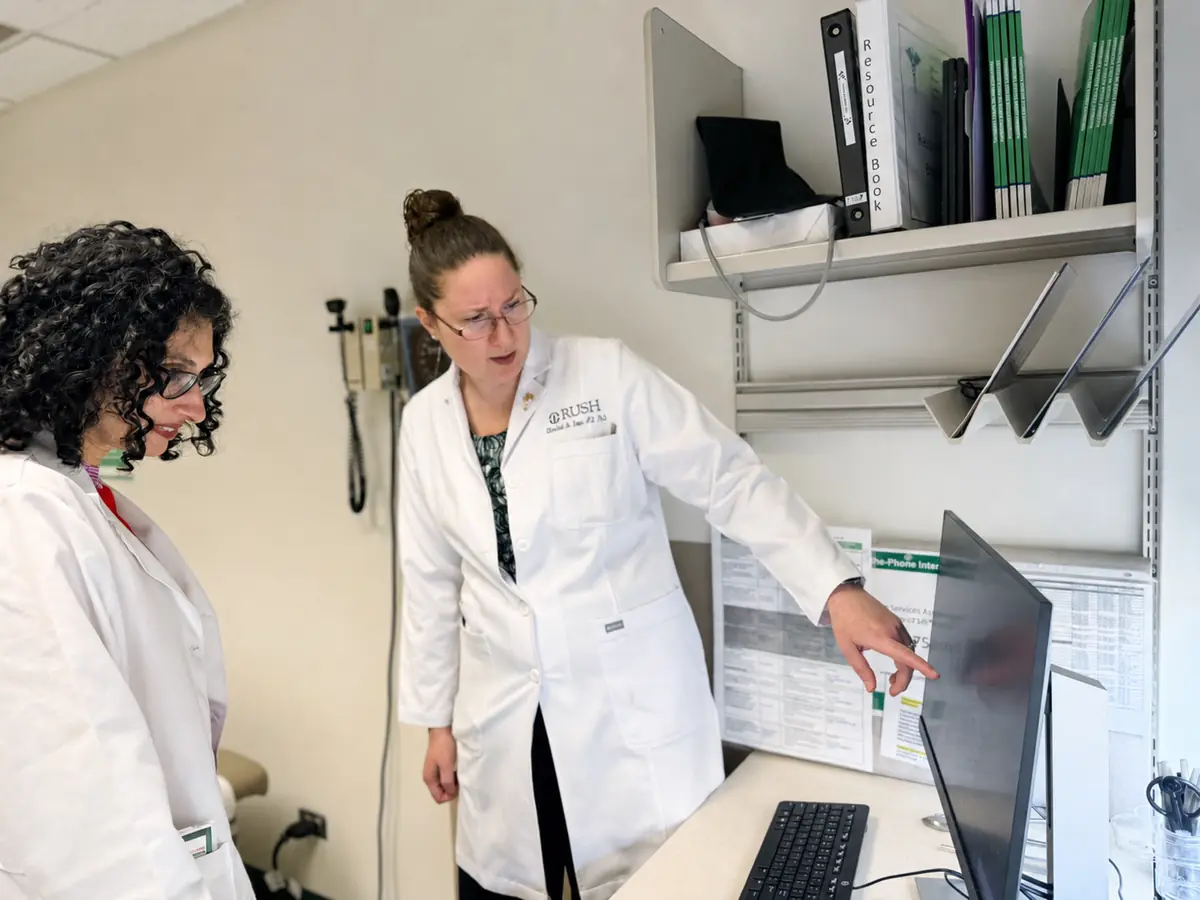 Two RUSH clinicians going through a patient's case together at a clinic workstation