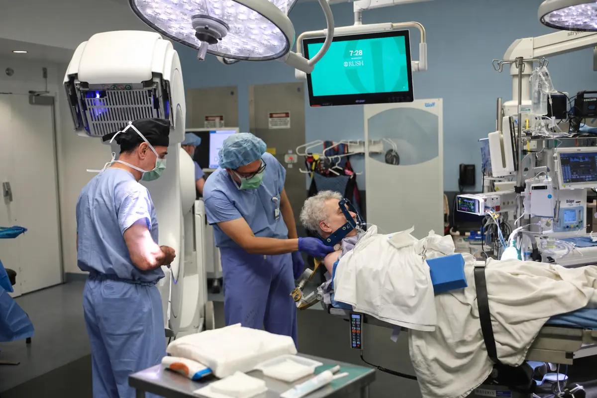 The operating room team positioning a patient at the start of DBS surgery