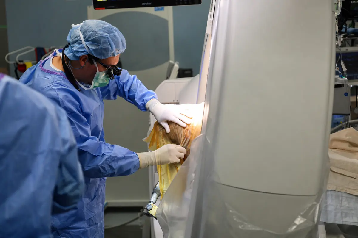 A surgeon preparing and draping the scalp before the skull opening is made
